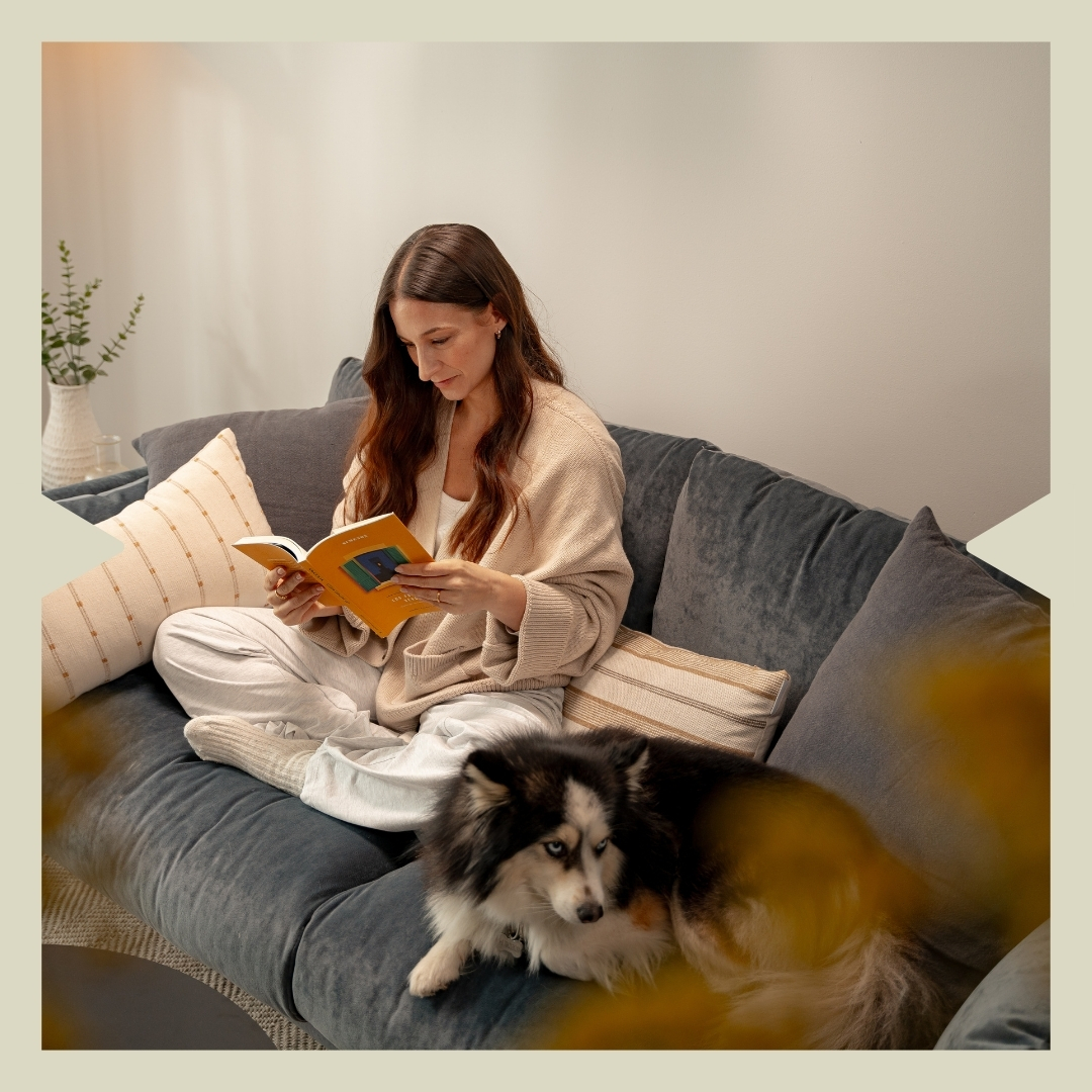 Woman reading with her dog in a pet-friendly apartment at Calido Living in Madrid