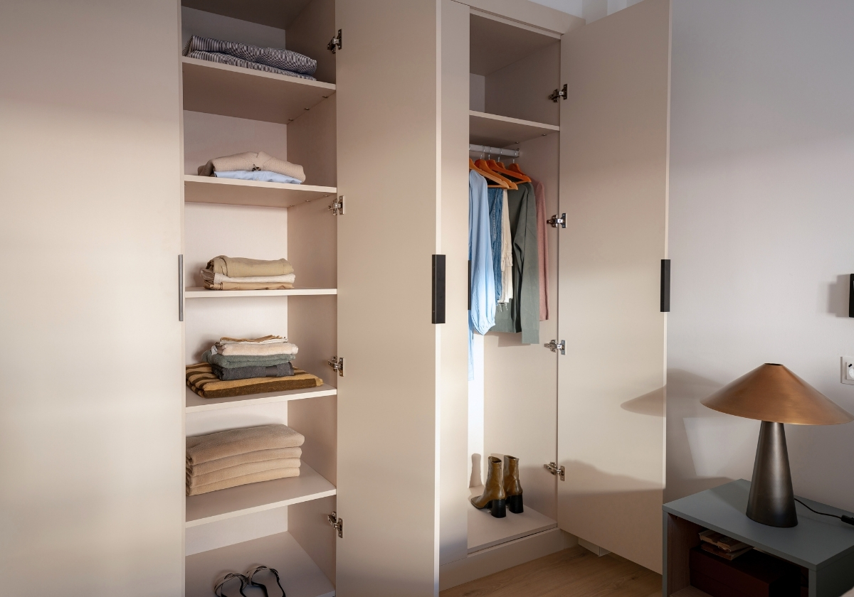 Armario con ropa y calzado organizado, en un dormitorio de Calido Living Alcobendas.